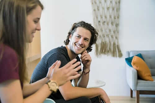 aftercare program follow up care rehab aftercare man smiling and talking to woman california addiction treatment center