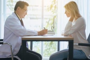 Woman and doctor discuss heroin detox