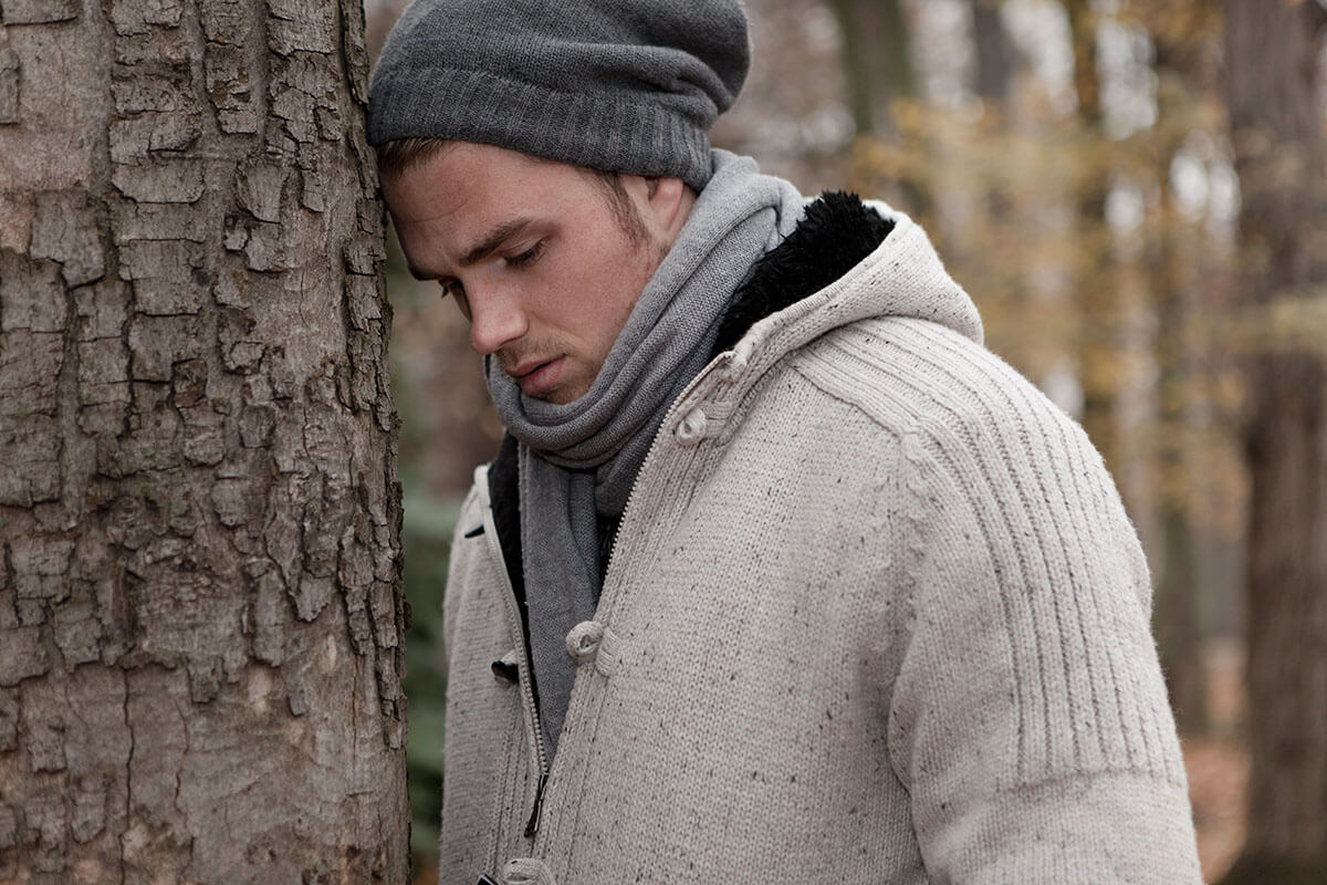 Man leaning against a tree questions whether addiction is a disease