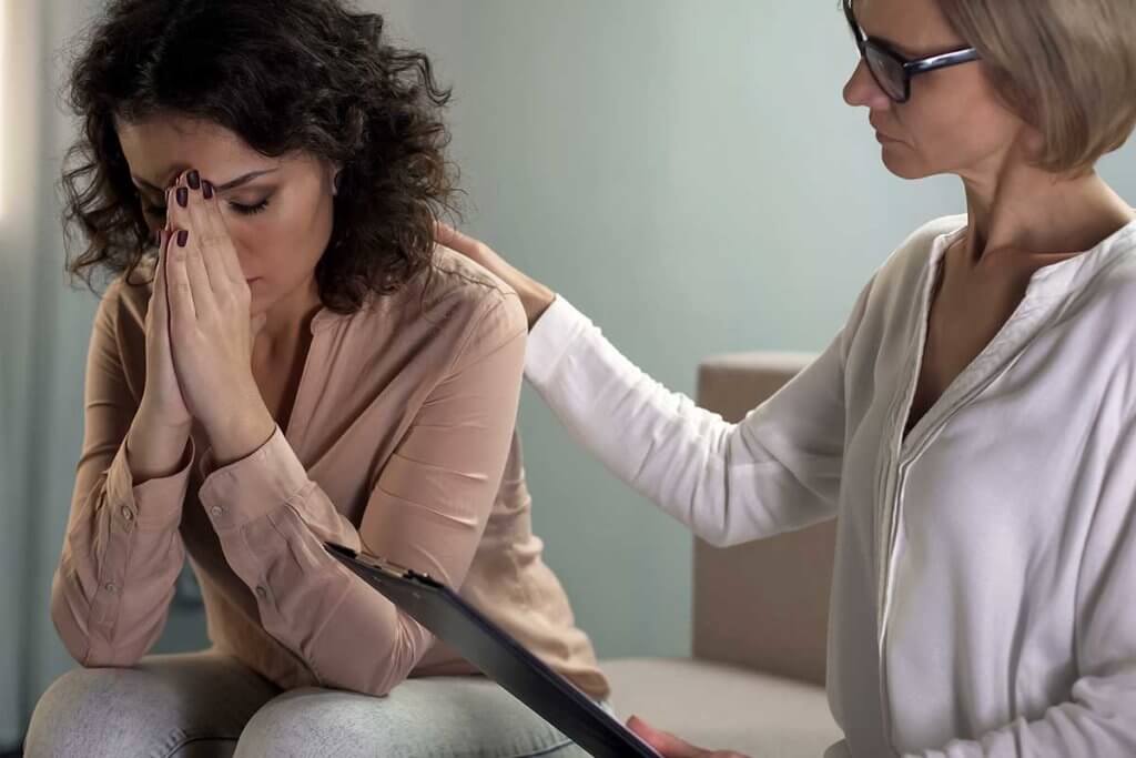 woman with therapist learning what is trauma informed care