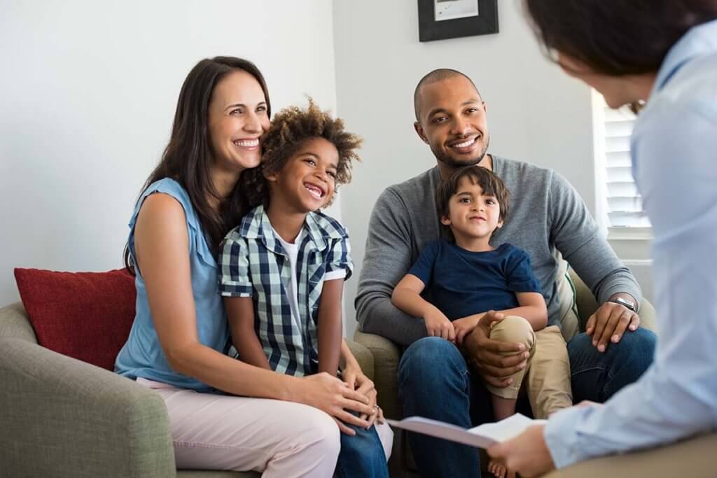 a doctor explaining to a family the benefits of a family program