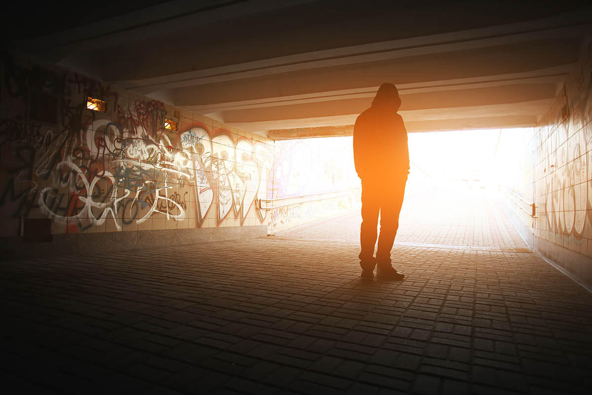 a person standing under an overpass thinking about heroin addiction recovery rate