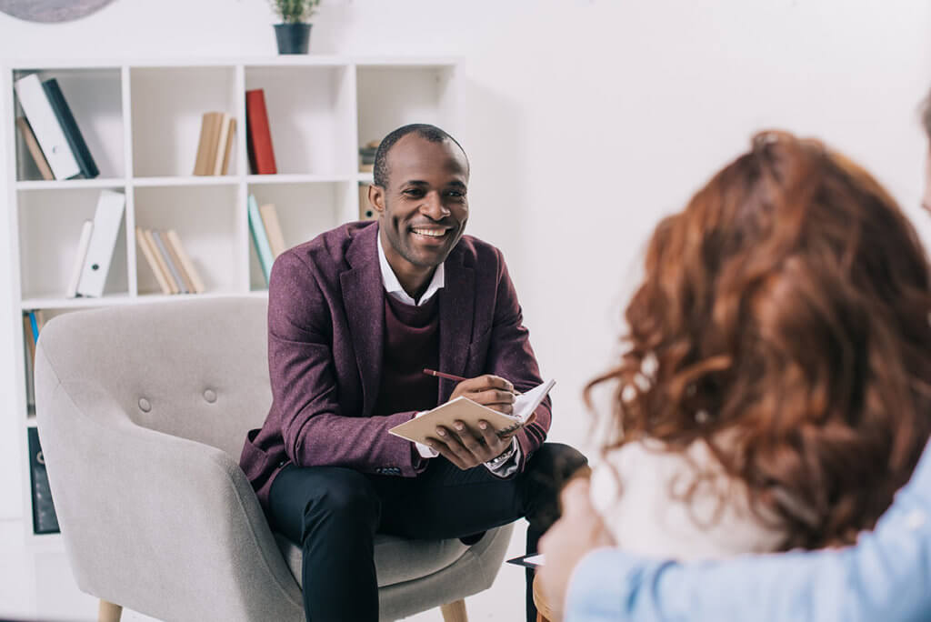 a doctor explaining psychotherapy vs counseling to a new patient and her family
