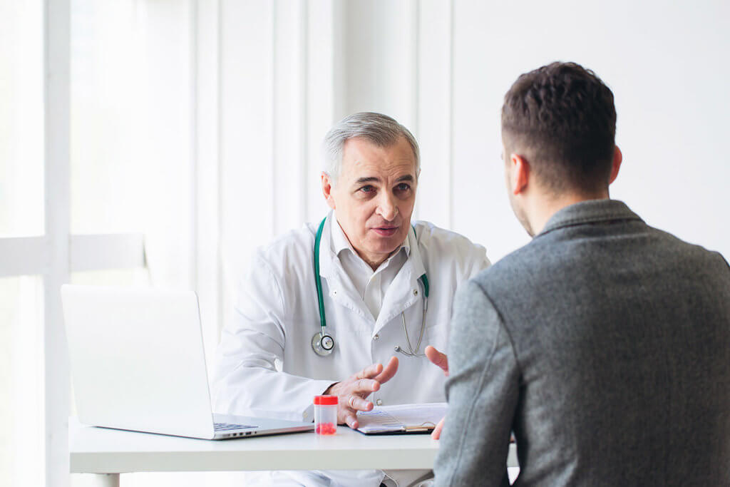 a doctor explaining to a patient about the results of his substance abuse assessment