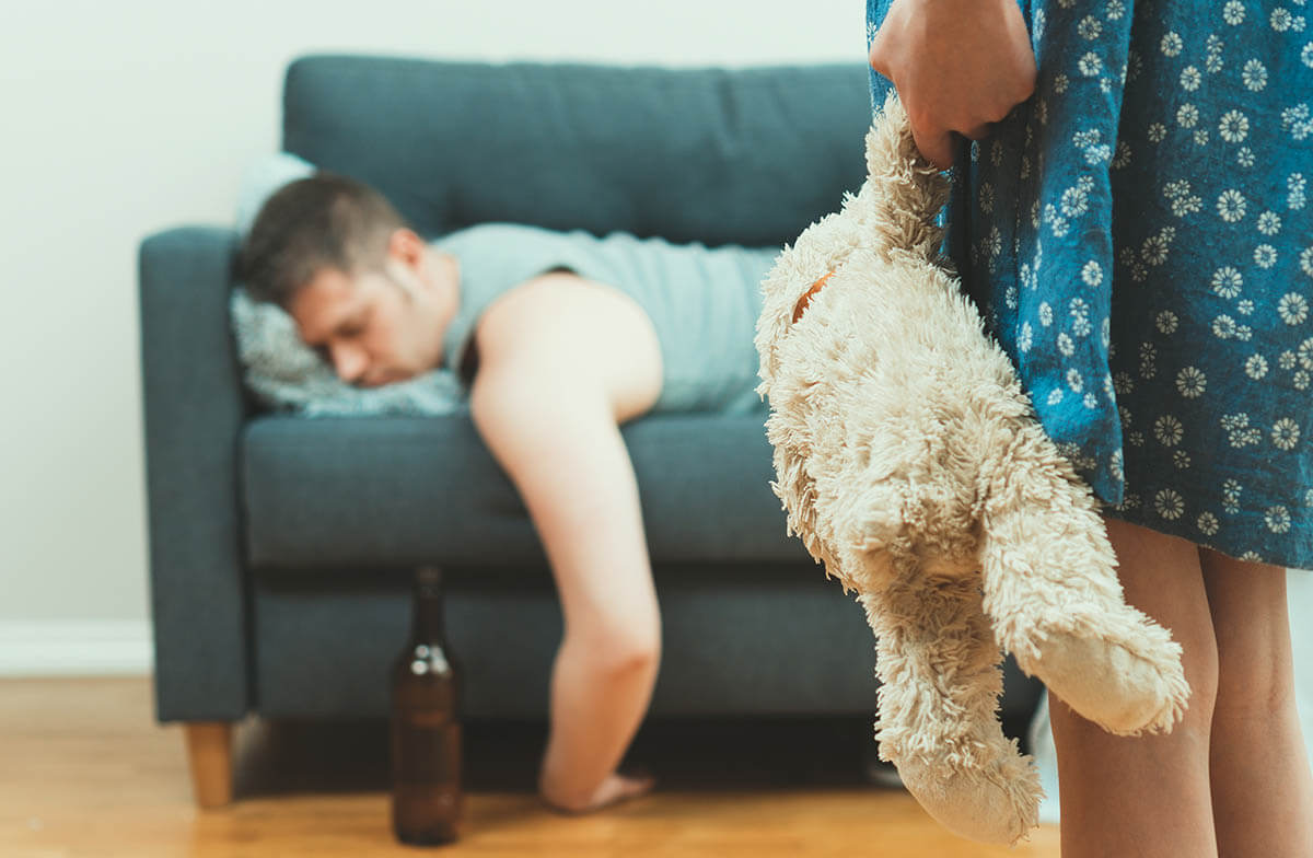 father passed out on couch with child watching seeing how addiction affects children