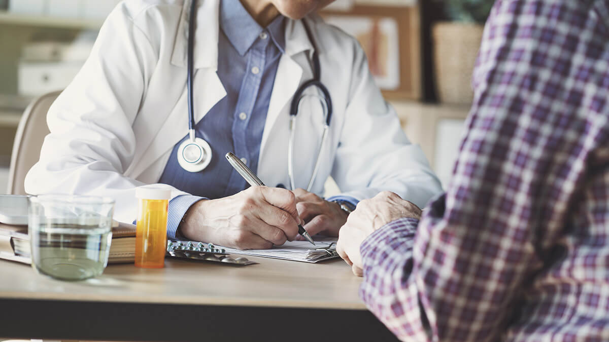 doctor writing down medication assisted treatment statistics