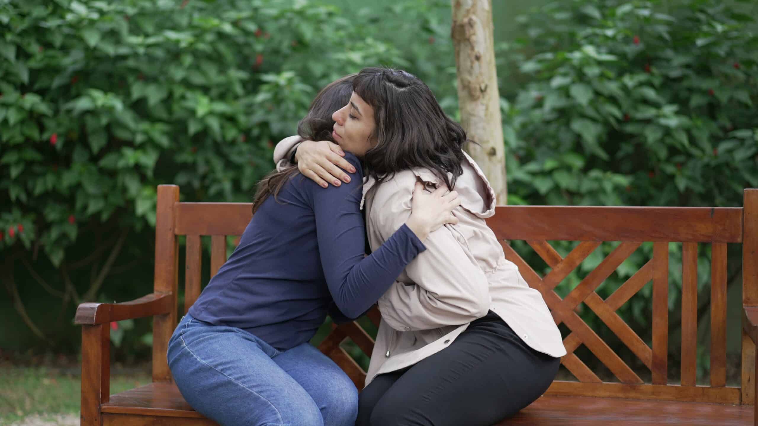 Woman receiving peer support from her friend whos also in addiction recovery