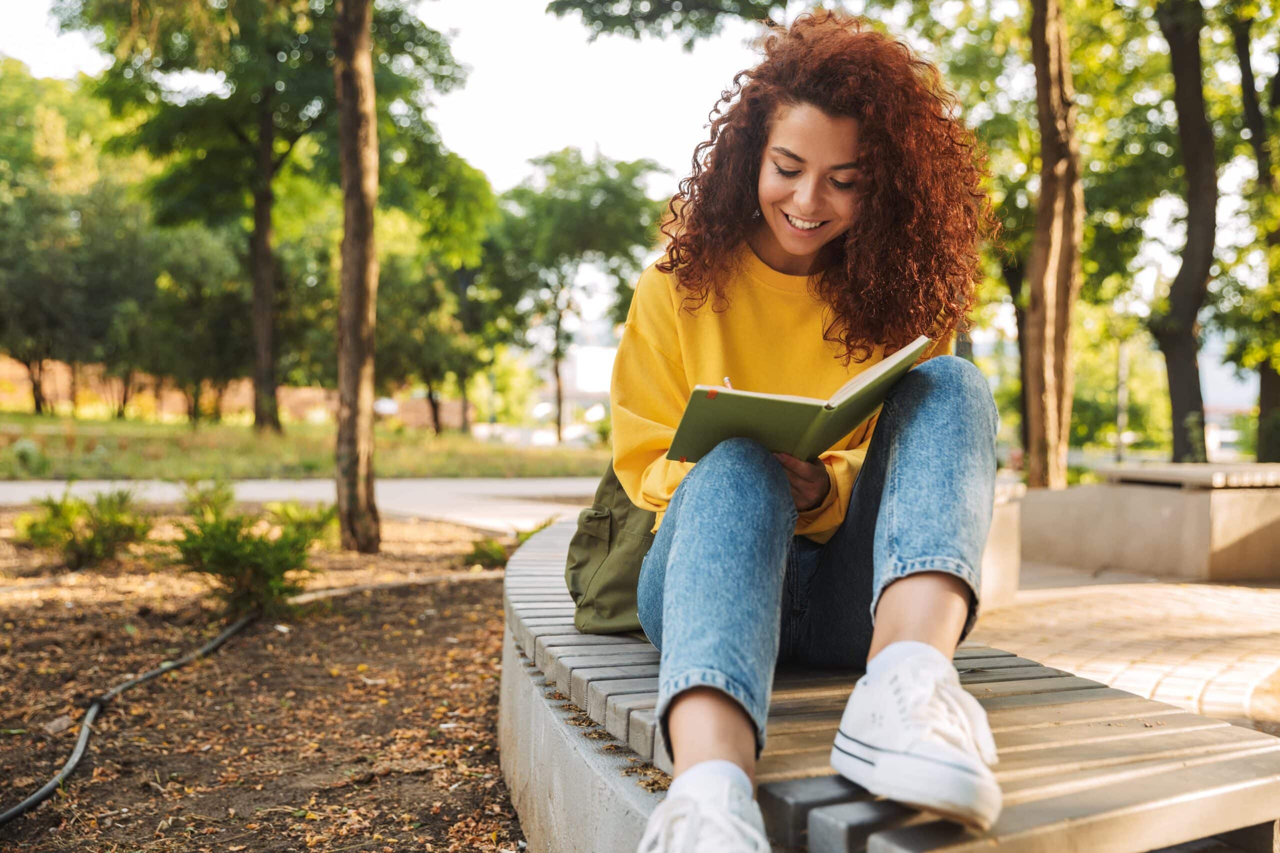 Woman reading 25 of the best sobriety affirmations