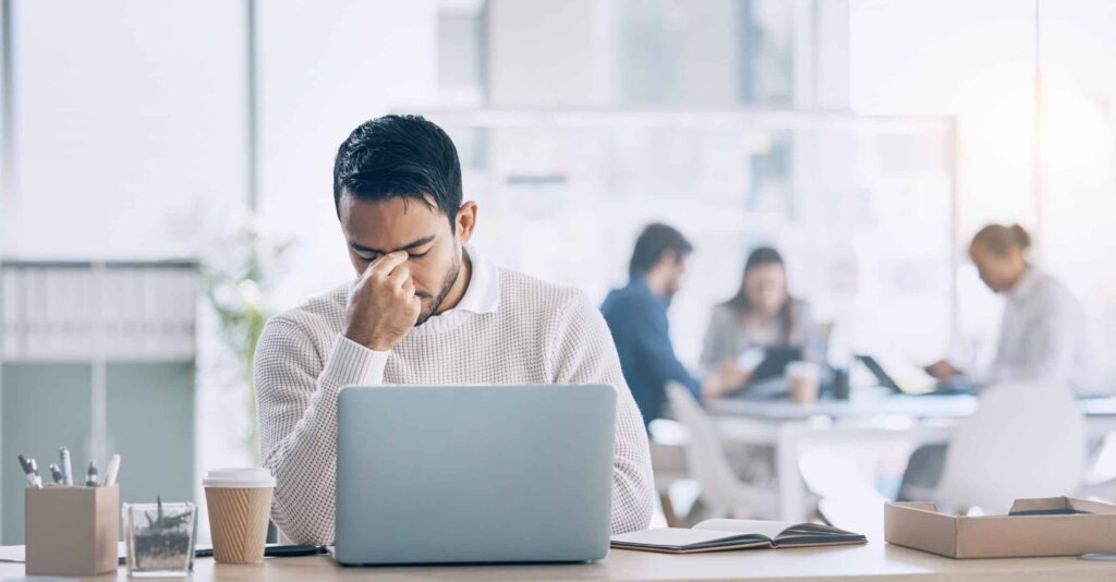 Man experiencing the symptoms of high-functioning depression at work