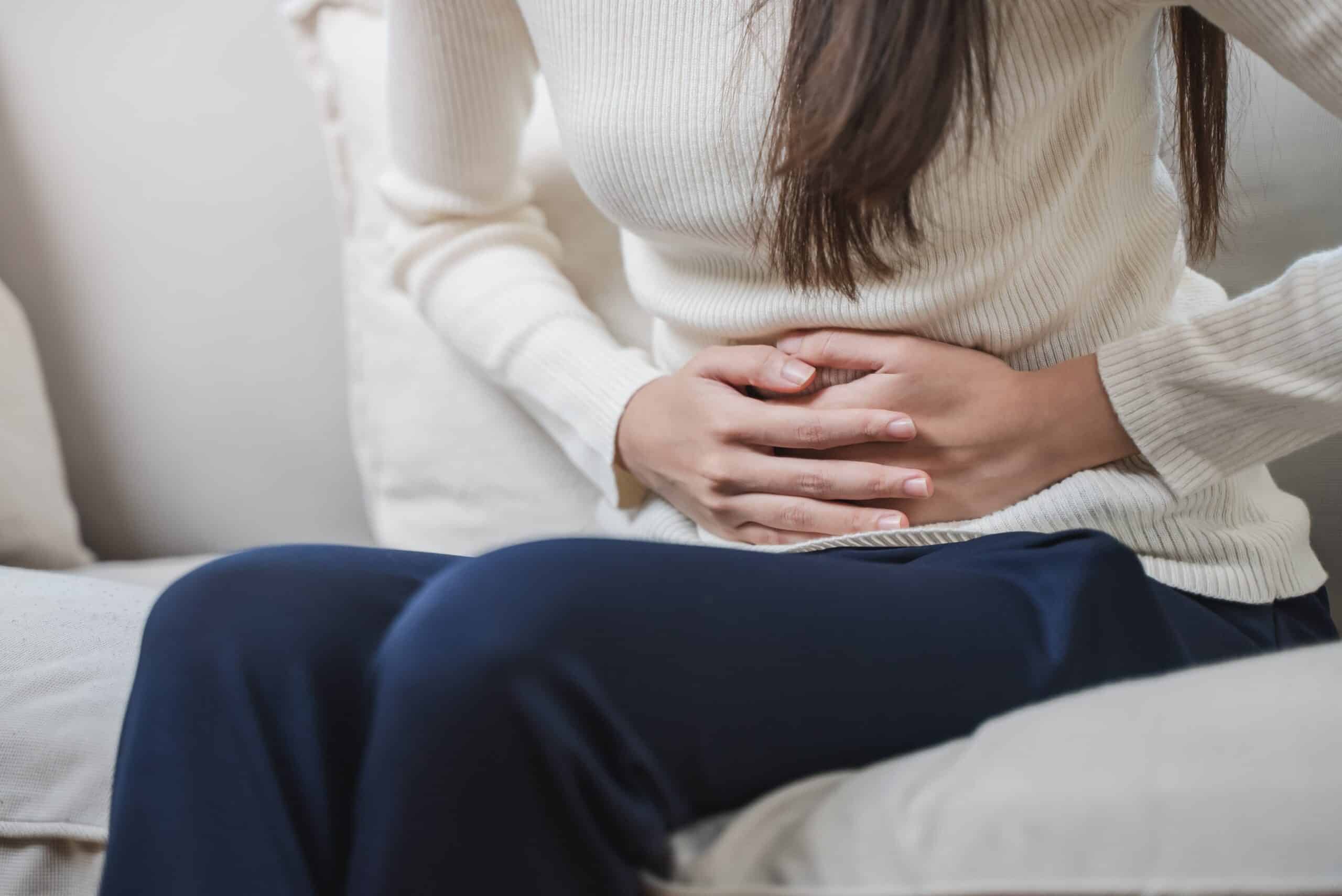 Woman wondering, how does alcohol affect your period?